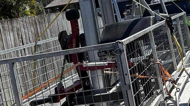 Gym equipment and bulky items loaded on a trailer for removal
