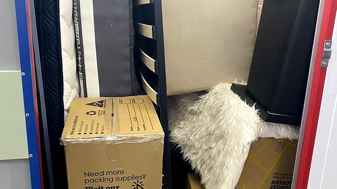 Furniture, mattresses and boxes stacked in storage ready to be cleared